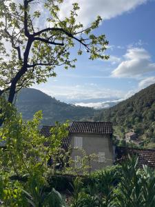 a view of a house with mountains in the background at Lortu vivu in Castifao