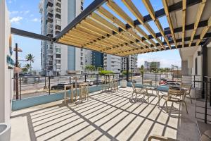 a patio with chairs and tables on a balcony at Ocean Breeze in San Juan