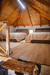 a attic room with two beds and a wooden floor at Etno kuca Drina in Loznica