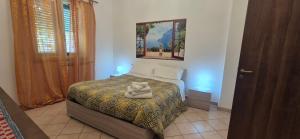a bedroom with a bed with two towels on it at Casa Nicole - Letojanni Taormina in Letojanni