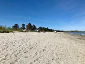 a beach with footprints in the sand and water at Ferienwohnung Michel in Glücksburg