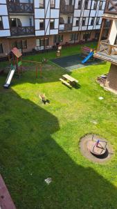 a park with a playground in the grass at Apartament Riva in Rowy