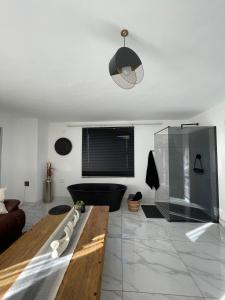 a living room with a couch and a tv at Team Sek Guest Studio in Mahikeng