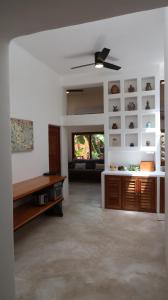 a living room with a ceiling fan and a couch at Casa Mayali - Walk to Lagoon in Bacalar
