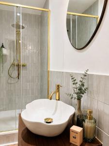 a bathroom with a white sink and a mirror at L'Escapade Mussipontaine in Pont-à-Mousson