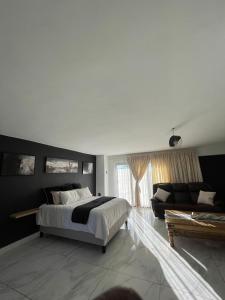 a bedroom with a bed and a couch at Team Sek Guest Studio in Mahikeng