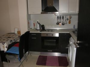 a small kitchen with a stove and a sink at Apartment Horisont 1 in Sozopol