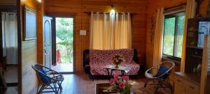 a living room with a couch and a table and chairs at Wonderville Villa in Cuncolim