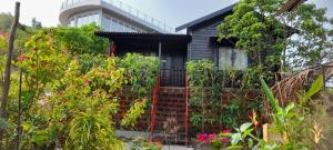 a house with a gate and some plants at Wonderville Villa in Cuncolim