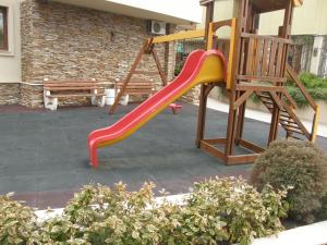 a slide on a playground in a yard at Apartment Horisont 1 in Sozopol