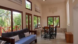 a living room with a couch and a table at Casa Mayali - Walk to Lagoon in Bacalar