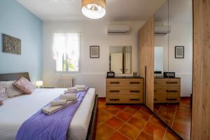 a bedroom with a bed with a dresser and a mirror at Villa Balata di Modica con piscina privata in Ragusa +43 photos