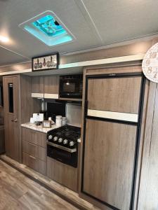 a kitchen with a stove and a stove top oven at Paradise RV in Tampa