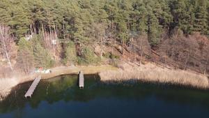 an aerial view of a lake with two bridges at Dependance Ferienhäuser am Kastavensee in Lychen
