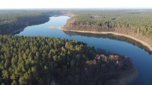 an aerial view of a river and forests at Dependance Ferienhäuser am Kastavensee in Lychen