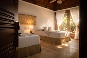 a bedroom with two beds and a window at Villa Alda Bávaro in Punta Cana +57 photos