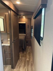 a small room with a bed and a bathroom at Paradise RV in Tampa