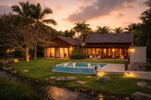 a villa with a swimming pool and a house at Villa Alda Bávaro in Punta Cana