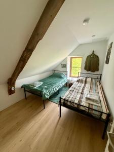 a bedroom with two bunk beds in a attic at Comme en 40 in La Lande-sur-Drôme