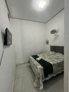 a bedroom with a bed in a white room at Studio - Serraruna in Araruna