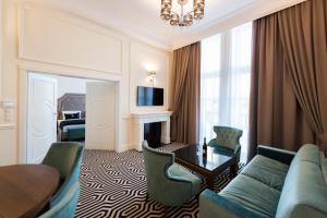 a living room with a couch and a table at Hotel Royal & Spa in Białystok