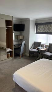 a hotel room with a bed and a table and chairs at The Farmers Kitchen Hotel in Wexford