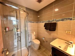 a bathroom with a toilet and a shower and a sink at treasure swimming condo in Chiang Mai