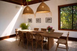 a dining room with a wooden table and chairs at Villa Alda Bávaro in Punta Cana