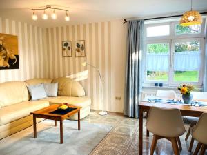 a living room with a couch and a table at Rosenhof Ferienwohnungen in Mölln-Medow +48 photos
