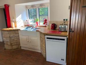 a kitchen with a sink and a counter top at 6 Bedroom Farm House with 12 Beds in Weldon in Weldon