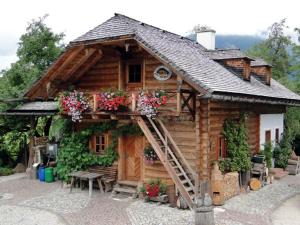 a log cabin with a staircase in front of it at Primushäusl Gästehaus in Strobl