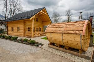 a large wooden cabin with a pitched roof at Primushäusl Gästehaus in Strobl