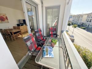 a balcony with a table and chairs on a balcony at Villa Annika - Whg 06 in Ostseebad Sellin +28 photos