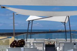 a table and chairs with a view of the ocean at House Barra Beach in Praia da Barra