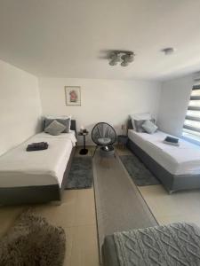 a living room with two beds and a window at Apartmani Teša in Tešanj