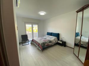a bedroom with a bed and a mirror at Rifugio del Mare con piscina e palestra in Loano +7 photos