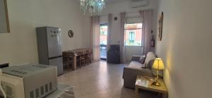 a living room with a couch and a refrigerator at Casa Nicole - Letojanni Taormina in Letojanni