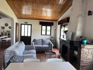 a living room with a couch and a fireplace at Pinho Azul - Beach House in Apúlia