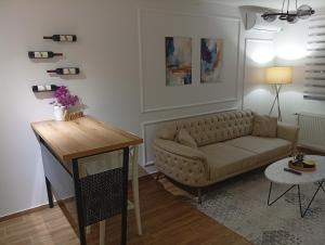 a living room with a couch and a table at Mozart apartman in Bijeljina