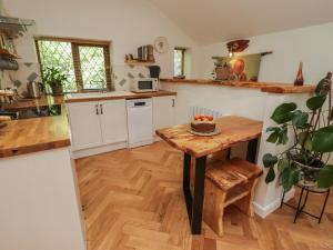 a kitchen with a table with a cake on it at Cân yr adar in Bridgend
