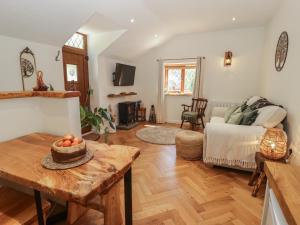 a living room with a table and a couch at Cân yr adar in Bridgend