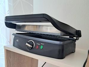 a black toaster oven sitting on top of a counter at Tolle Economy Stay in Padova