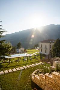 a view of a house with a fence and a yard at Chalet Bellavista in Spiazzi Di Caprino
