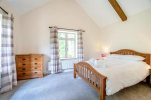 a bedroom with a large bed and a window at 4 Bed in Taunton oc-w35167 in West Monkton