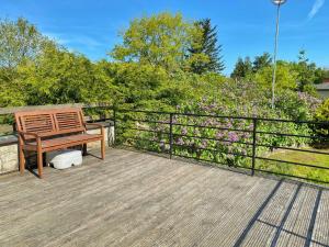 a wooden bench sitting on top of a wooden deck at Ferienhaus Hete in Staphel