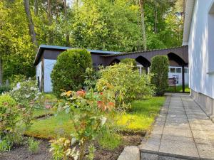 a garden with flowers and plants in front of a house at Ferienhaus Hete in Staphel +11 photos