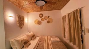a bedroom with a bed with a ceiling fan at Solenta trace 01 in El Nido