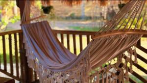 a hammock on a porch with a view of a yard at Solenta trace 01 in El Nido