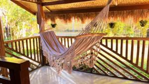 a hammock on a porch with a view of a river at Solenta trace 01 in El Nido