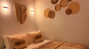 a bedroom with a bed with hats on the wall at Solenta trace 01 in El Nido +2 photos